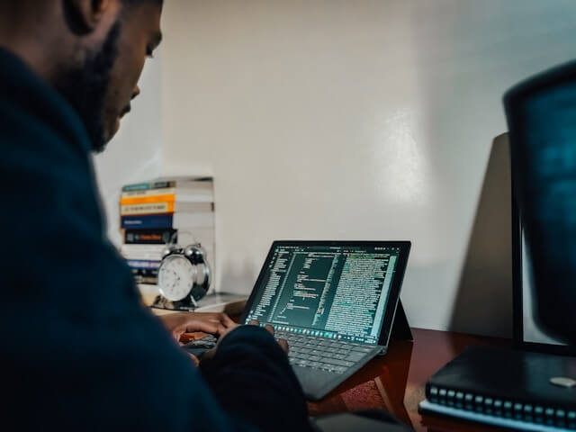 Person working remotely on a personal laptop — illustrating BYOD risks for small businesses